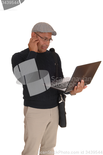 Image of A Hispanic man working on his laptop.