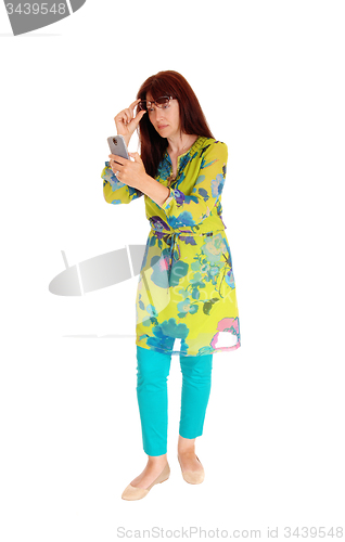 Image of Businesswoman looking at cell phone.