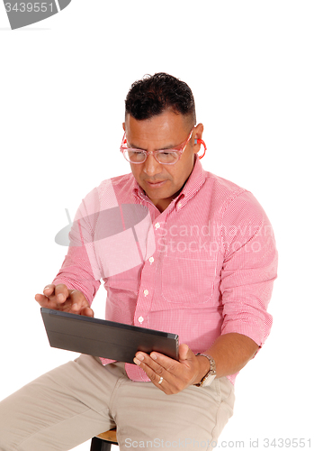 Image of Closeup of man working on tablet pc.