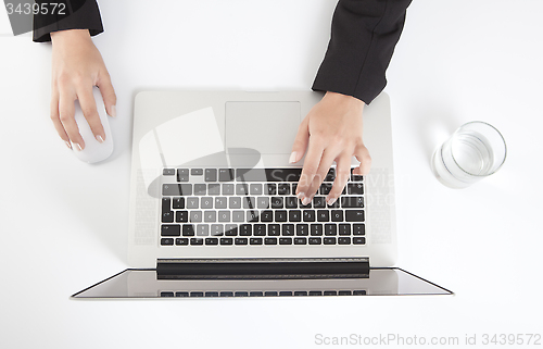 Image of Woman writes on a laptop