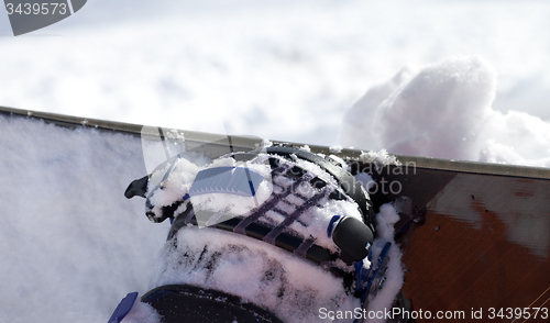 Image of Snowboard and boot in binding on off-piste slope