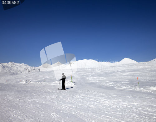 Image of Skier on ski slope at sun day