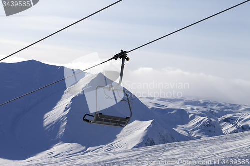 Image of Chair lift and mountains in evening