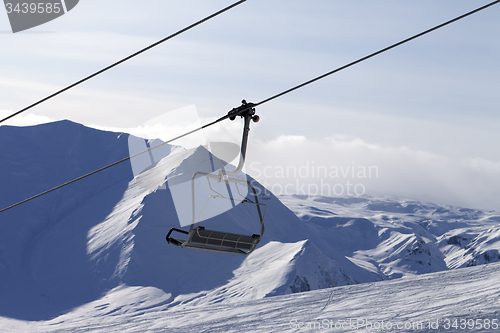 Image of Chair lift and mountains in evening