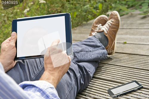 Image of Using a tablet outside 