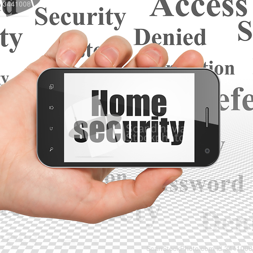 Image of Security concept: Home Security on Hand Holding Smartphone display