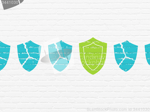 Image of Security concept: shield icon on wall background