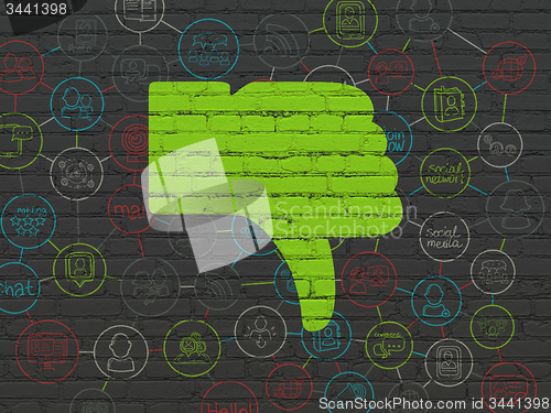 Image of Social network concept: Thumb Down on wall background