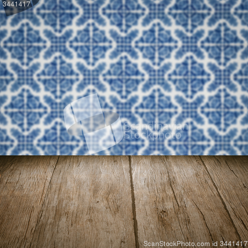 Image of Wood table top and blur vintage ceramic tile pattern wall