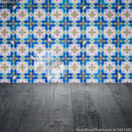 Image of Wood table top and blur vintage ceramic tile pattern wall
