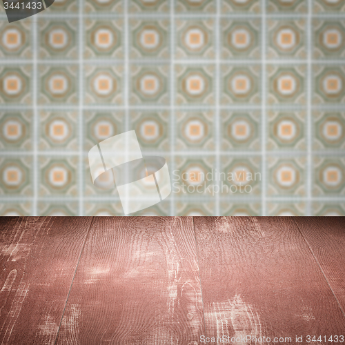 Image of Wood table top and blur vintage ceramic tile pattern wall