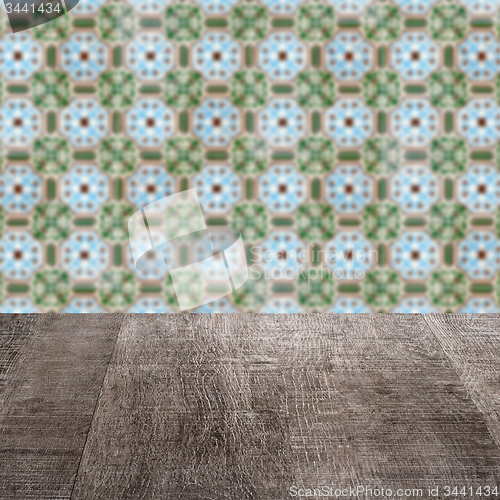 Image of Wood table top and blur vintage ceramic tile pattern wall