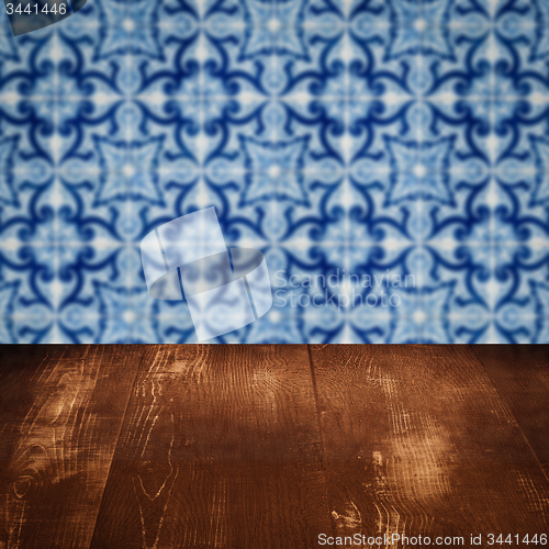 Image of Wood table top and blur vintage ceramic tile pattern wall