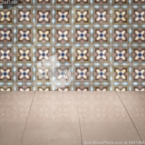 Image of Wood table top and blur vintage ceramic tile pattern wall