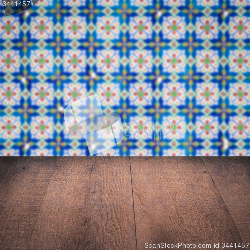 Image of Wood table top and blur vintage ceramic tile pattern wall