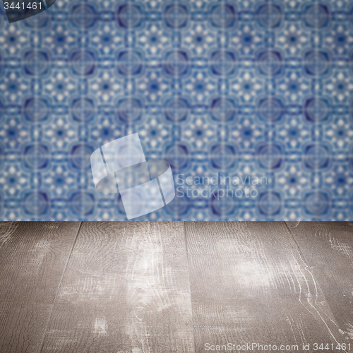 Image of Wood table top and blur vintage ceramic tile pattern wall