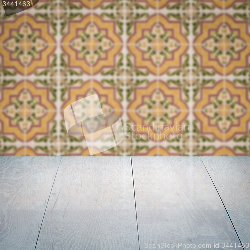 Image of Wood table top and blur vintage ceramic tile pattern wall