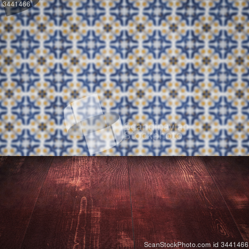 Image of Wood table top and blur vintage ceramic tile pattern wall