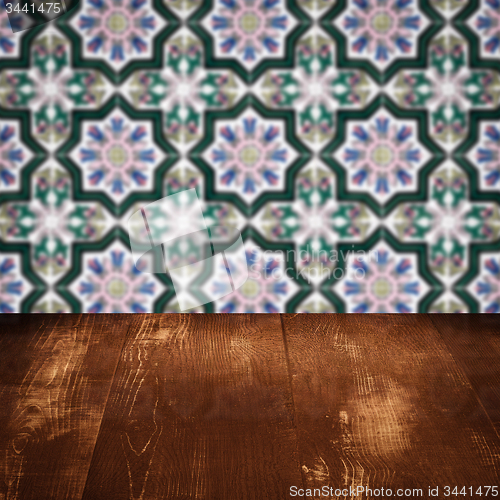 Image of Wood table top and blur vintage ceramic tile pattern wall