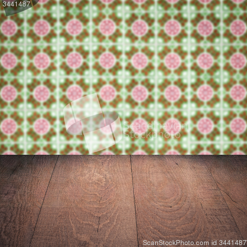 Image of Wood table top and blur vintage ceramic tile pattern wall