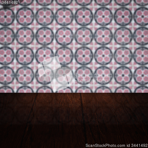 Image of Wood table top and blur vintage ceramic tile pattern wall