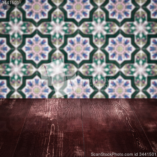 Image of Wood table top and blur vintage ceramic tile pattern wall