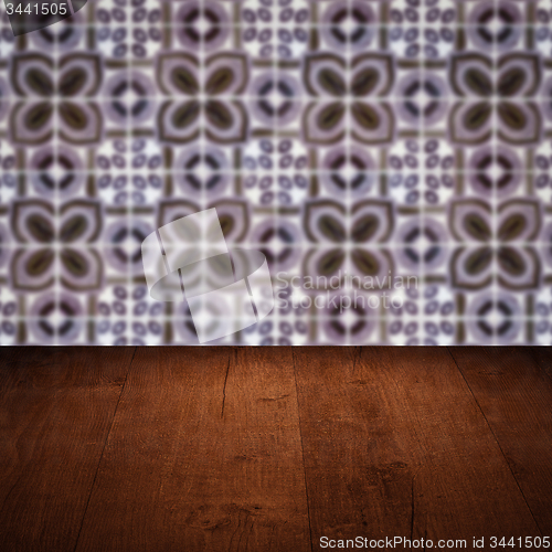 Image of Wood table top and blur vintage ceramic tile pattern wall