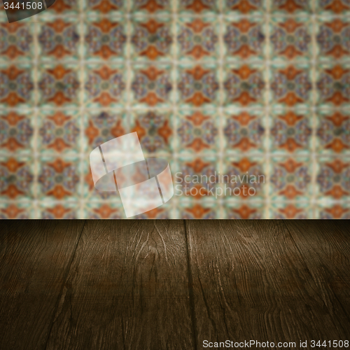 Image of Wood table top and blur vintage ceramic tile pattern wall