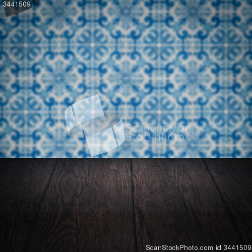 Image of Wood table top and blur vintage ceramic tile pattern wall
