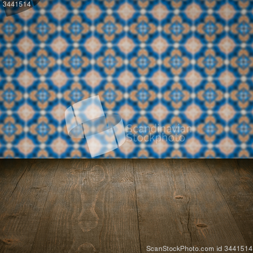 Image of Wood table top and blur vintage ceramic tile pattern wall