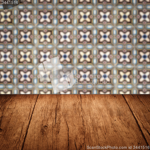 Image of Wood table top and blur vintage ceramic tile pattern wall