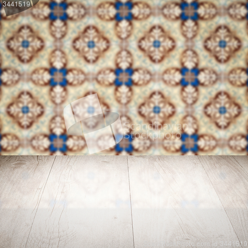 Image of Wood table top and blur vintage ceramic tile pattern wall
