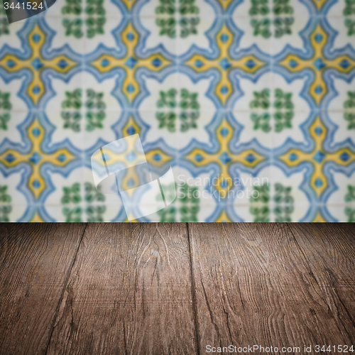 Image of Wood table top and blur vintage ceramic tile pattern wall