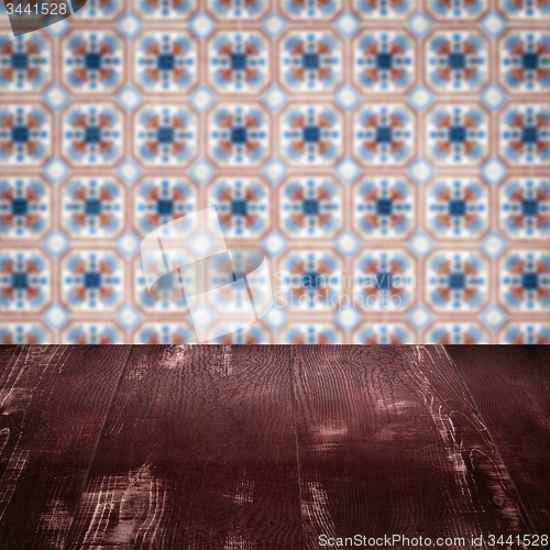 Image of Wood table top and blur vintage ceramic tile pattern wall