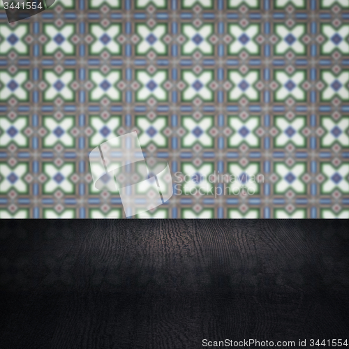 Image of Wood table top and blur vintage ceramic tile pattern wall