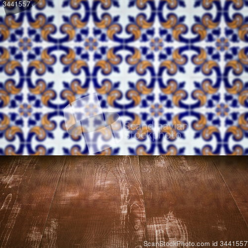 Image of Wood table top and blur vintage ceramic tile pattern wall