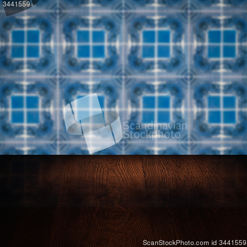 Image of Wood table top and blur vintage ceramic tile pattern wall