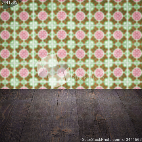 Image of Wood table top and blur vintage ceramic tile pattern wall