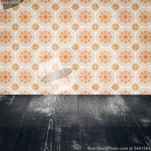Image of Wood table top and blur vintage ceramic tile pattern wall