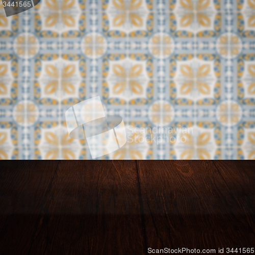 Image of Wood table top and blur vintage ceramic tile pattern wall