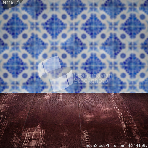 Image of Wood table top and blur vintage ceramic tile pattern wall