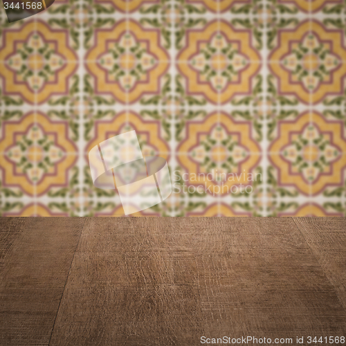 Image of Wood table top and blur vintage ceramic tile pattern wall