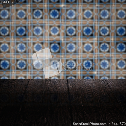 Image of Wood table top and blur vintage ceramic tile pattern wall