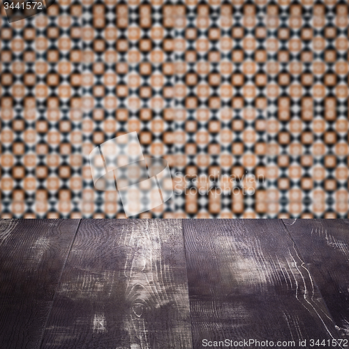 Image of Wood table top and blur vintage ceramic tile pattern wall