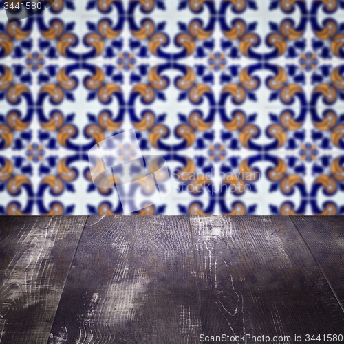 Image of Wood table top and blur vintage ceramic tile pattern wall