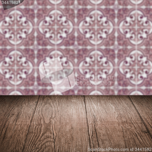 Image of Wood table top and blur vintage ceramic tile pattern wall