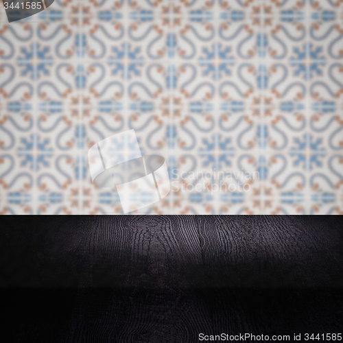 Image of Wood table top and blur vintage ceramic tile pattern wall