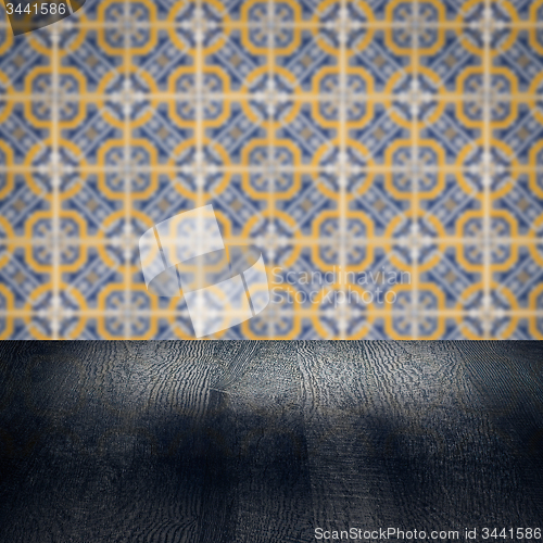 Image of Wood table top and blur vintage ceramic tile pattern wall