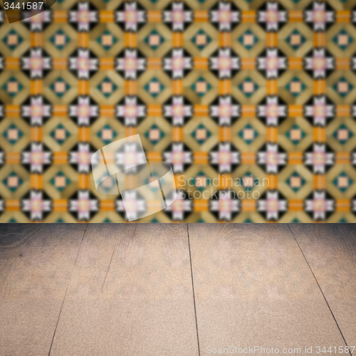 Image of Wood table top and blur vintage ceramic tile pattern wall