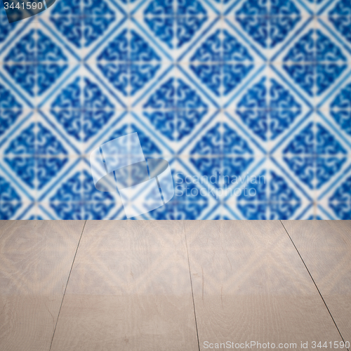 Image of Wood table top and blur vintage ceramic tile pattern wall